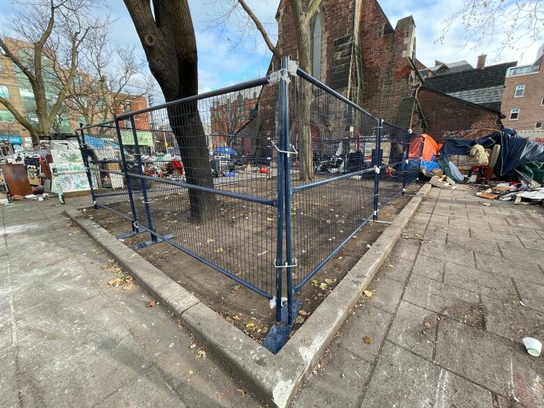 Fences erected in front of the Toronto church where the encampment stood.