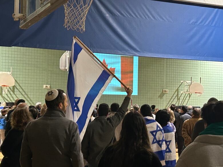 A person holding up a flag. 