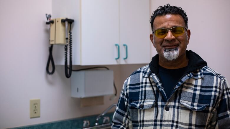 A man stands in a veterinarian office.