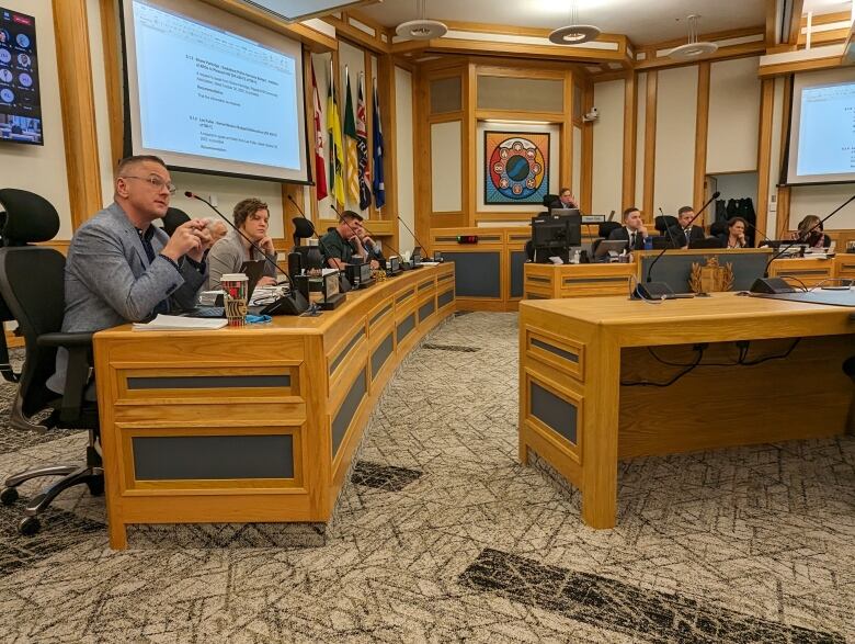 People sit at a city councillor bench