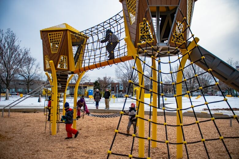 Children playing on a playground structure. 