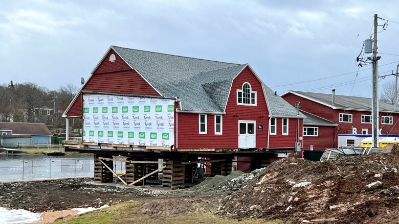 A red house-like building by a lake