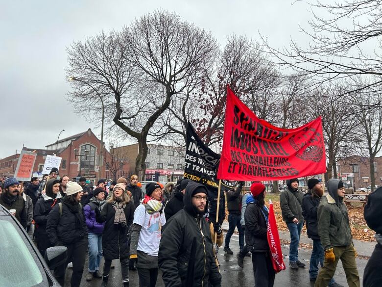 People march in the rain.