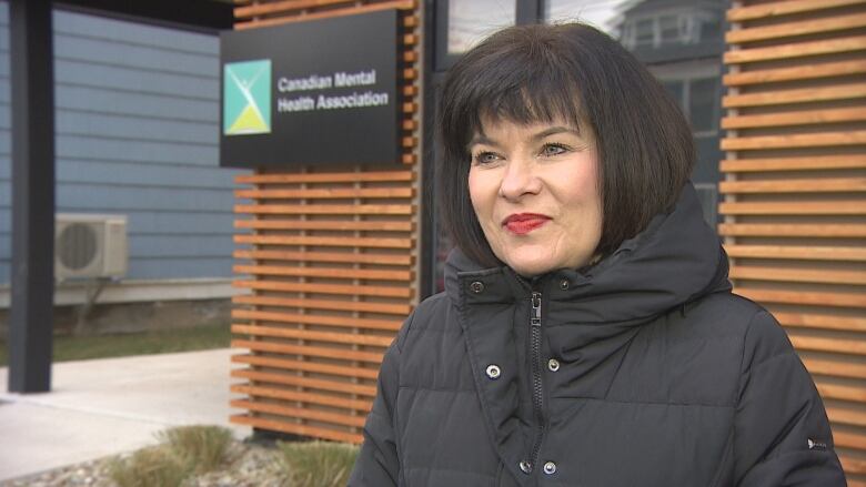 Federal minister of veterans affairs stands in front of the Canadian Mental Health Association office in Charlottetown. 