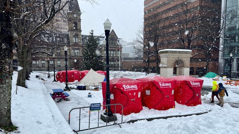 Red box-like shelters in front of a building.