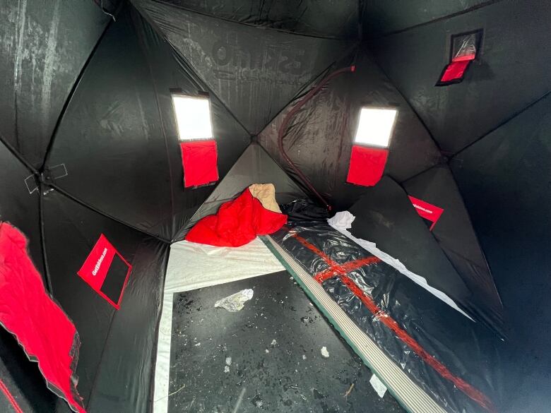 Black walls with red flaps and window surround a solid black floor.