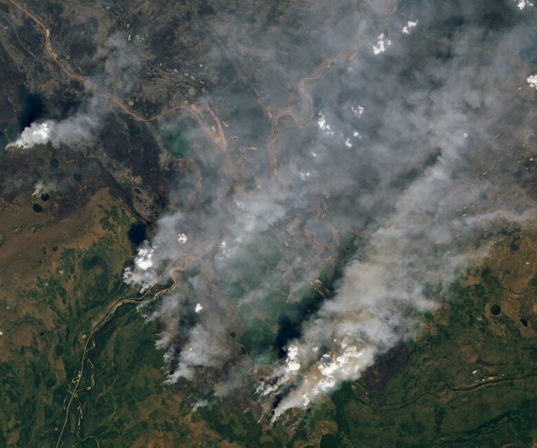 Aerial satellite view of heavy smoke rising in the air due to wildfires in Yellowknife, N.W.T.