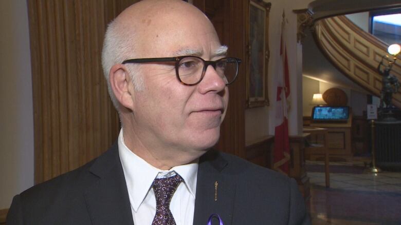 David Coon speaks to reporters in the rotunda of the New Brunswick Legislature.