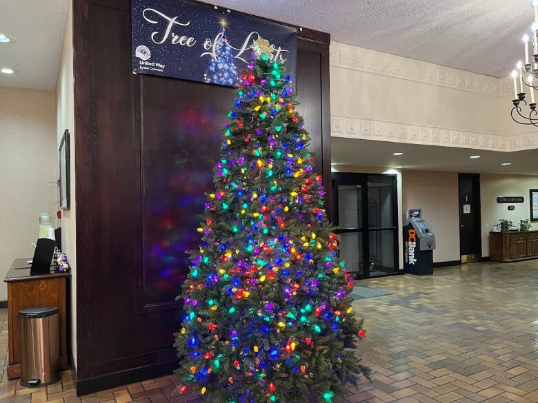 A Christmas tree is lit in a hotel lobby.