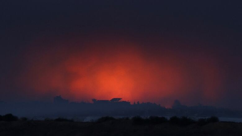 Fire burns and smoke rises following Israeli airstrikes in the Gaza Strip on Thursday.