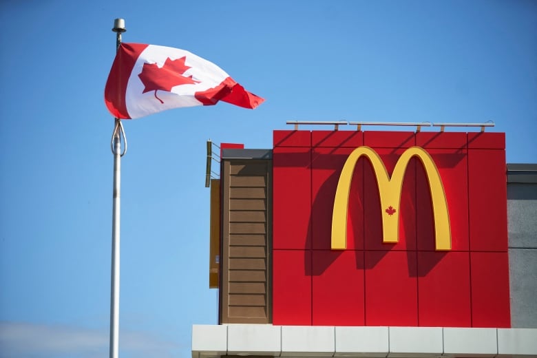 A Canadian flag flies outside a McDonald's restaurant in London, Ont., in a file photo from Sept. 2019.