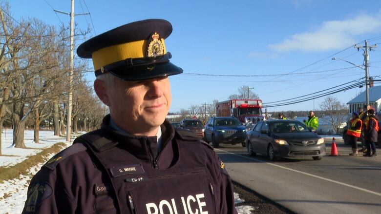 RCMP officer on side of road.