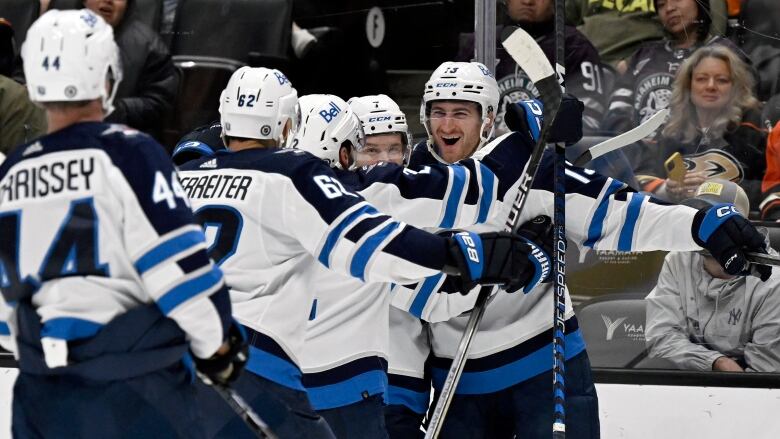 Hockey players in white and blue celebrate