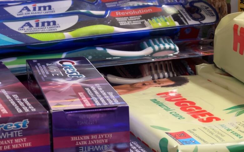 A photo shows toothpaste, brushes and wipes, ready to be put into hampers.