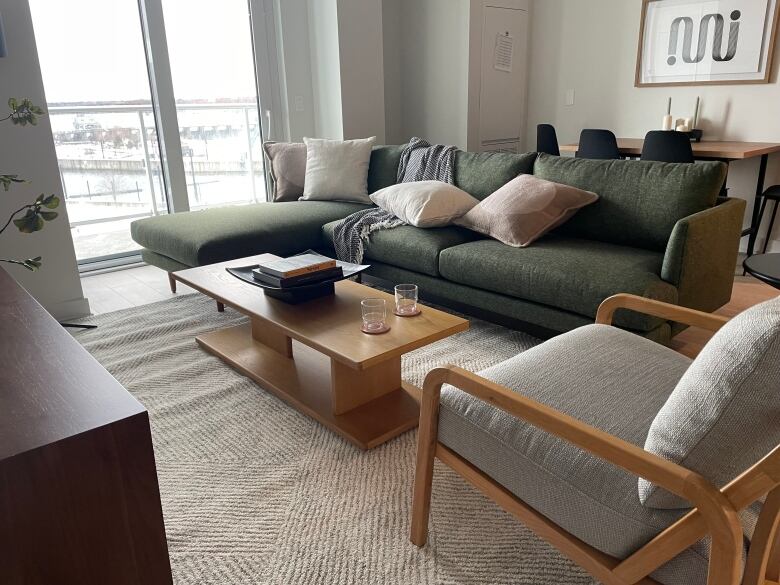 A living room with a couch, chair and coffee table.