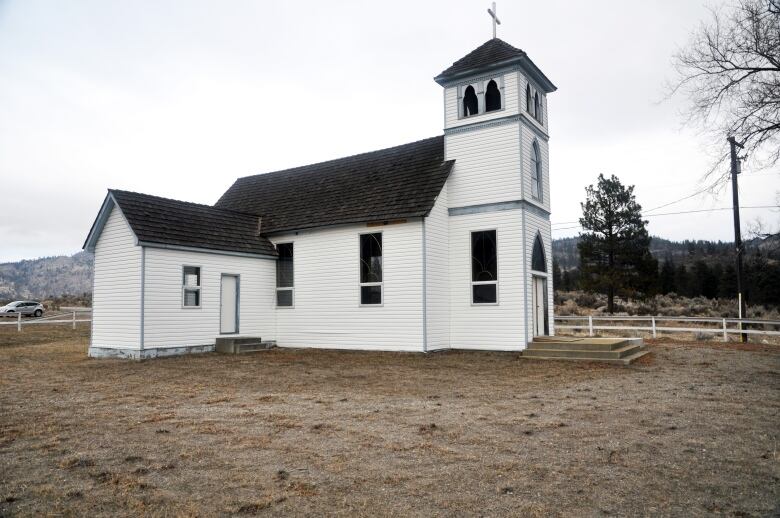 Small white church with a tall steeple.