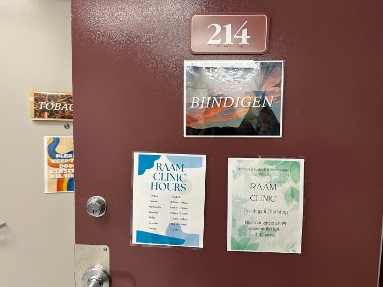 Three signs are taped to a door.