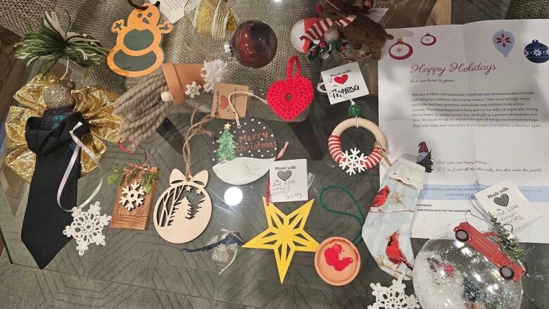 Several Christmas ornaments are spread out on what appears to be a couch cushion. 