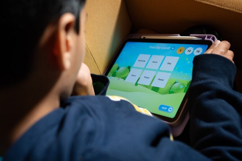 Rohan, 8, plays a LittleLit game on a tablet that uses AI to personalize the learning experience in Coquitlam, B.C. 