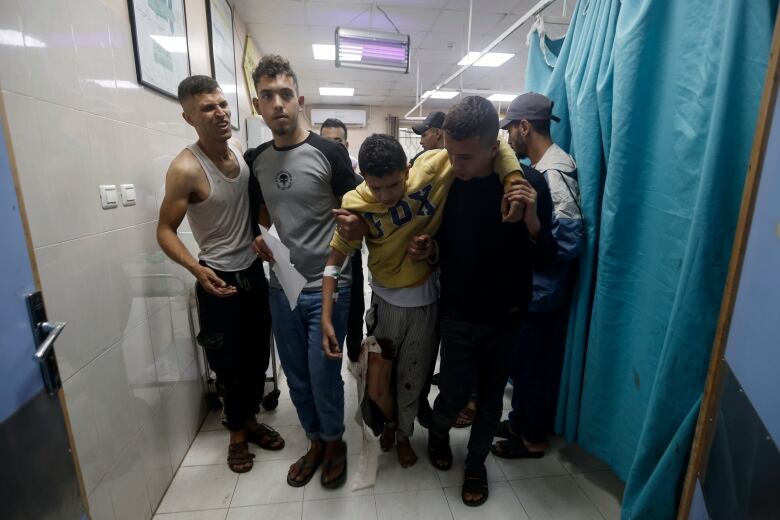 Palestinians wounded in Israeli airstrikes arrive at a  hospital.