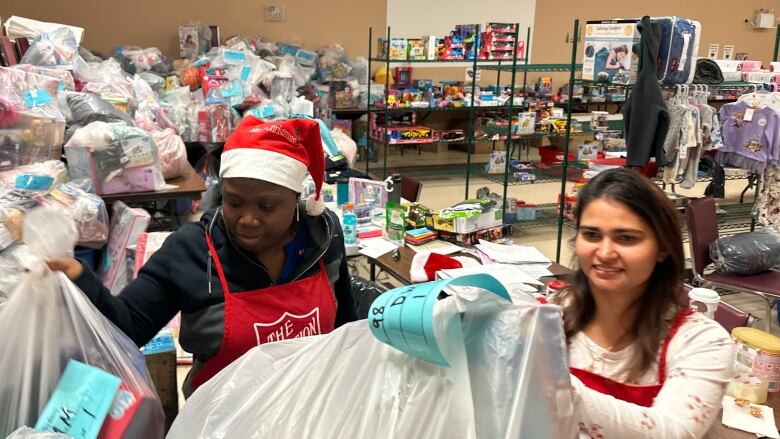 Workers at the Salvation Army in Sydney prepare toys for the annual Christmas distribution