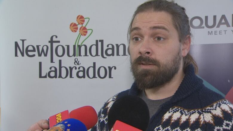 Eddy St. Coeur speaks to reporters at Quadrangle's office in St. John's. 