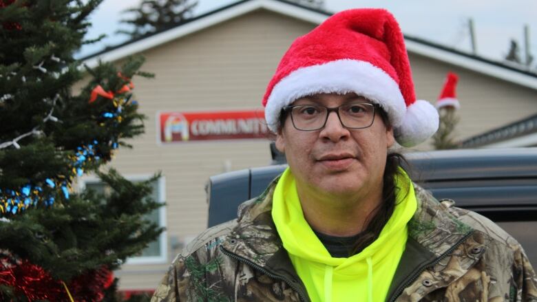 An Indigenous man in a Santa hat