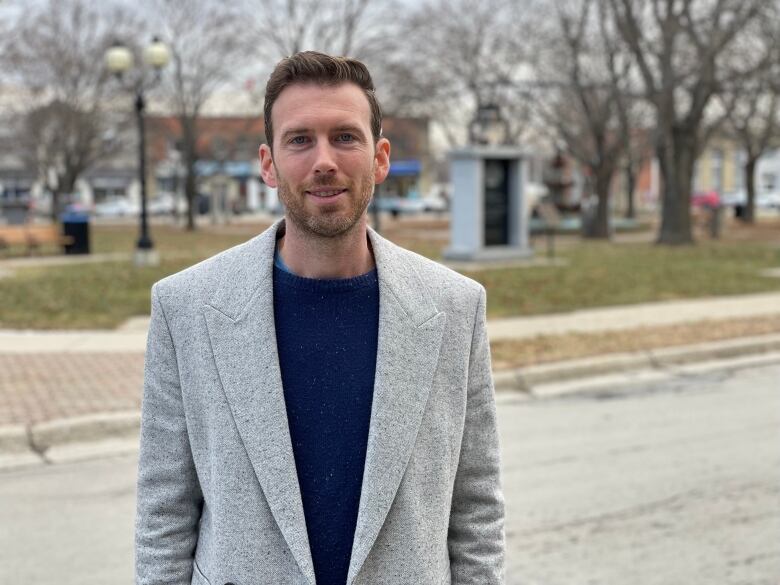 man in suit standing in park