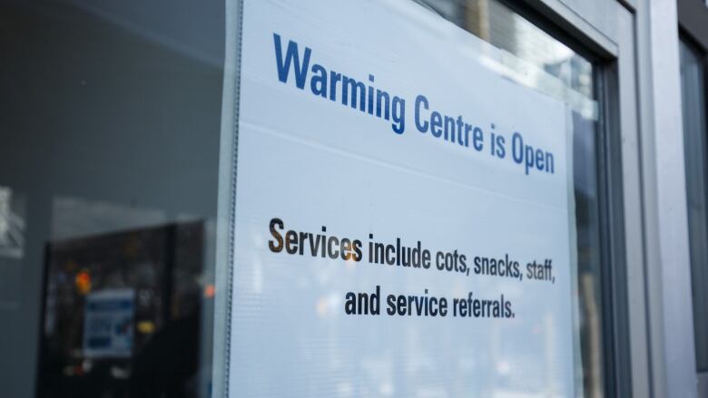 Signage for a warming centre is photographed at Metro Hall in Toronto, on Feb. 17, 2023.