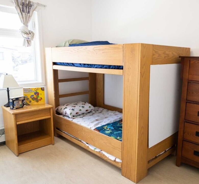 A small bunk bed in a child's bedroom. 