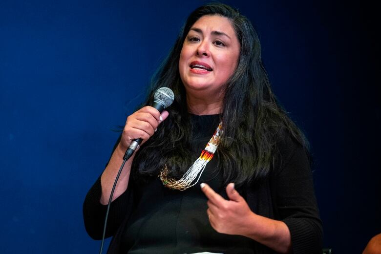 Woman speaking into a microphone