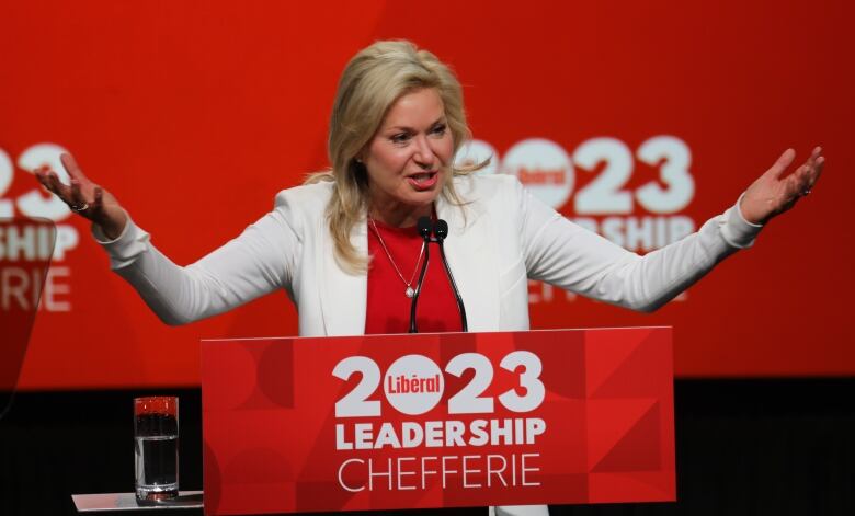 Bonnie Crombie gestures as she stands at a podium that says '2023 Liberal Leadership.'