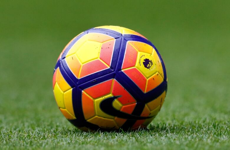 A view of a soccer ball on the grass.