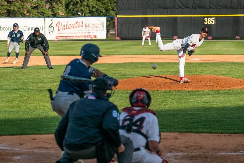 A pitcher throws a ball during a baseball game. 