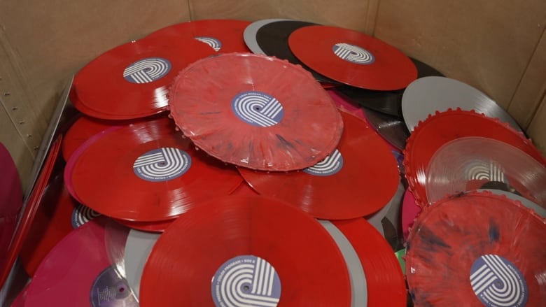 A bin filled with red vinyl LPs.