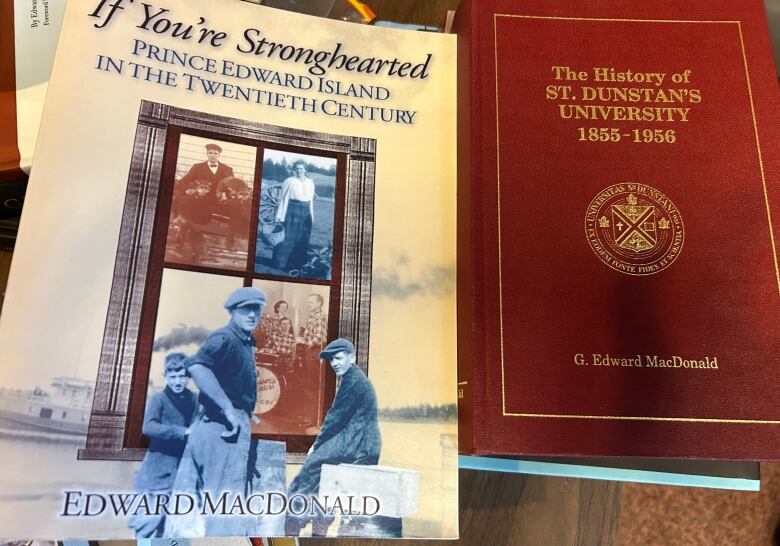 Two books are shown on a desk, both authored by Ed MacDonald. 