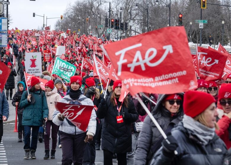 Striking teachers holding red FAE union flags