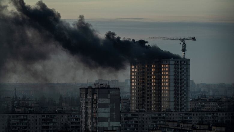 Black smoke rises for an apartment building.