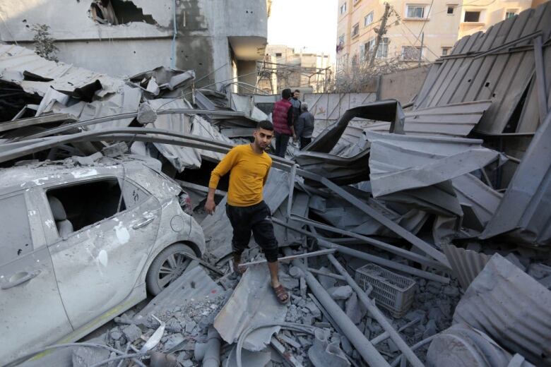 A man walks on rubble left from an airstrike.