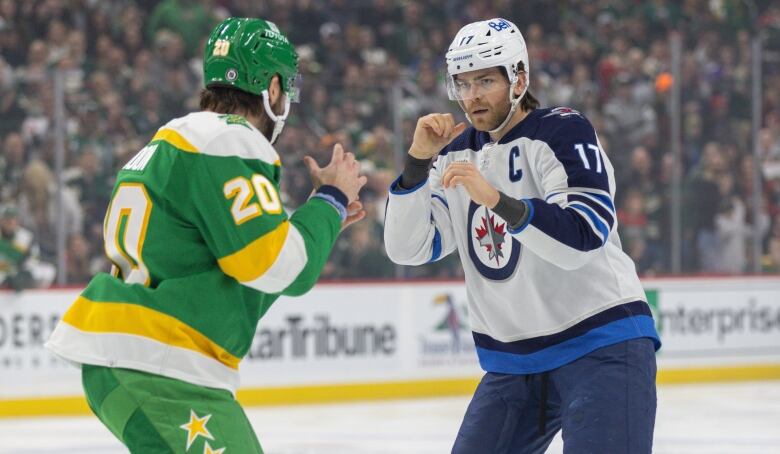 Two hockey players prepare for a scrap.