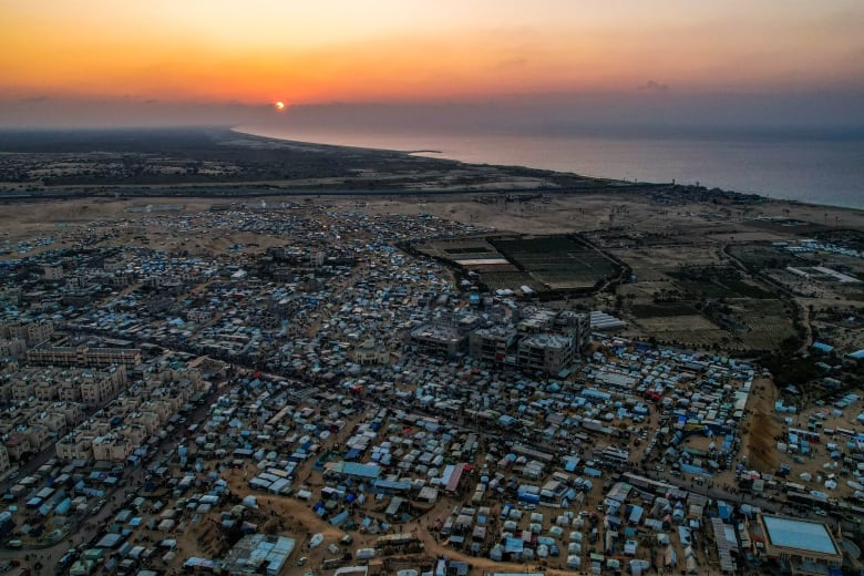 An aerial view shows tents set up at a large refugee camp.