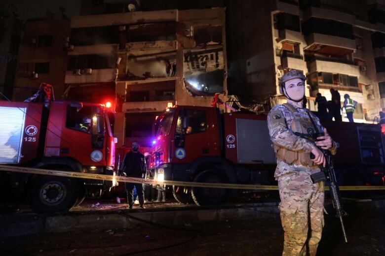 Lebanese soldiers guard a building reportedly targeted by an Israeli drone strike in Beirut.