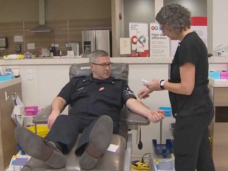 Man in EMS uniform gets blood drawn