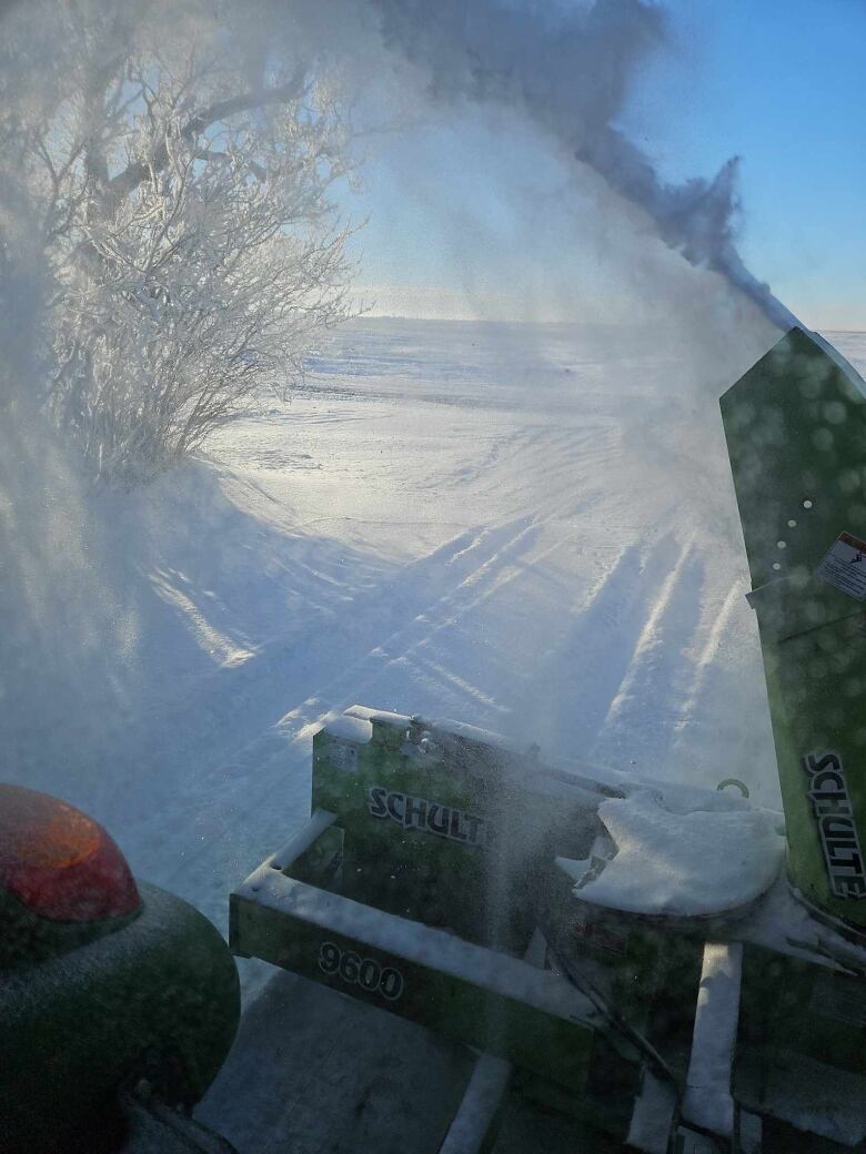 A snowblower clears snow.