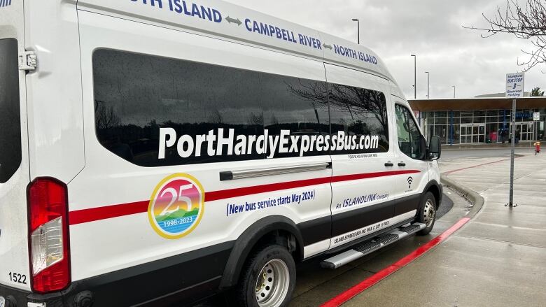 A small bus with the phrase, PortHardExpressBus.com printed on the side, is seen parked along a curb.