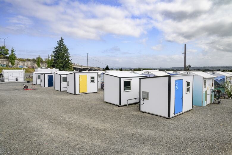 Small shed-like structures with colourful doors