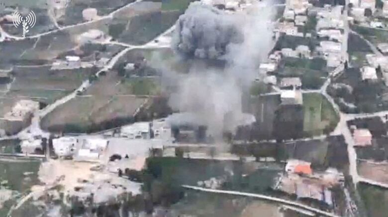 Smoke rises following a strike by Israeli military fighter jets on what the Israeli military says are Hezbollah targets in a location given as the area of Yaroun in Lebanon, amid the ongoing cross-border hostilities between Hezbollah and Israeli forces, in this screengrab taken from a video released on January 2, 2024.