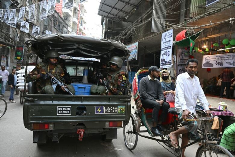 Soldiers patrol a neighbourhood in Dhaka, Bangladesh, a day ahead of the country's national election.