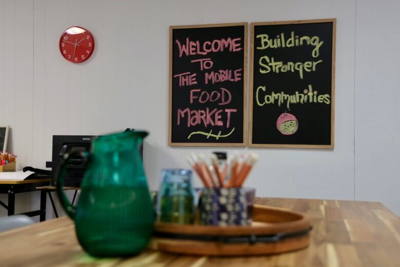 Two signs read, 'welcome to the mobile food market' and 'building stronger communities.'