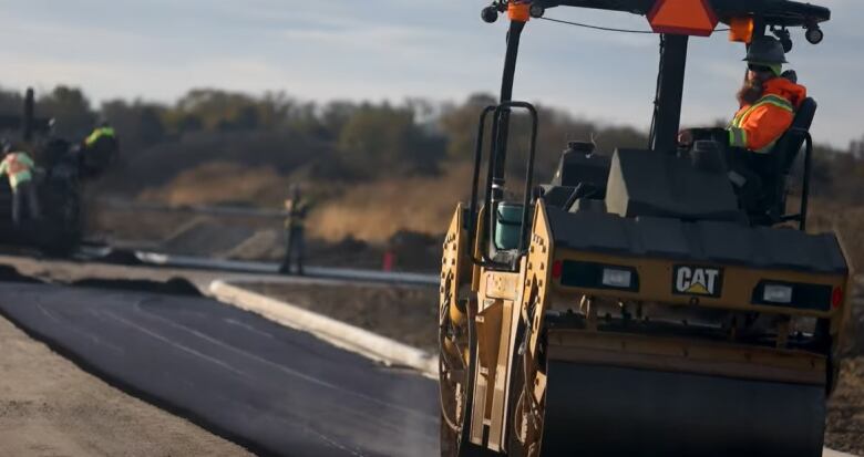 Crews pave a road on the Caldwell First Nation in Leamington.